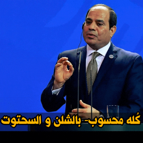 a man in a suit and tie is speaking into a microphone with a blue background