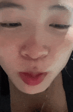 a close up of a woman 's face with a red lip