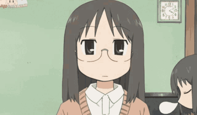 a girl wearing glasses is standing in front of a wall clock that shows the time as 10:12