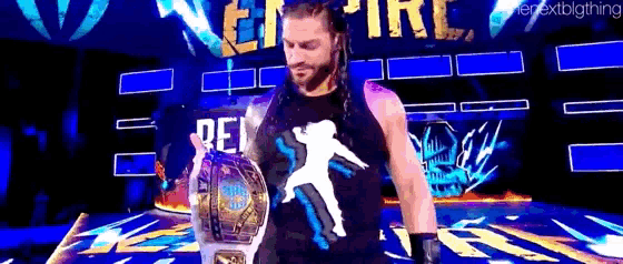 roman reigns is holding a world heavyweight championship belt while walking on a stage .