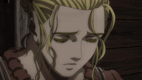 a close up of a woman 's face with her eyes closed and her hair in a ponytail