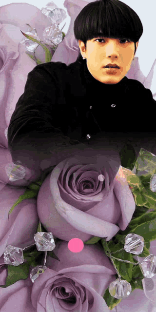 a man in a black shirt is surrounded by purple flowers