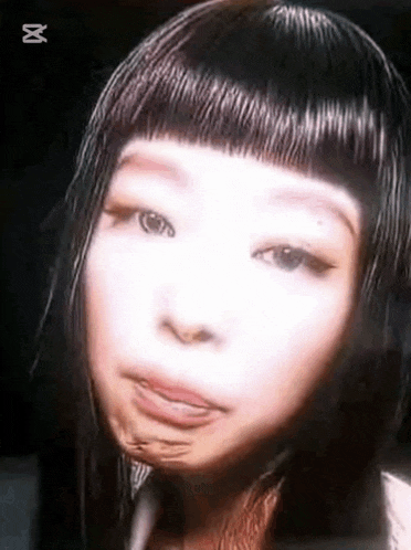 a close up of a woman 's face with a wig on and making a funny face .