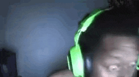 a man wearing a pair of green headphones is making a funny face .