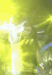a woman is dancing in front of a crowd in a club