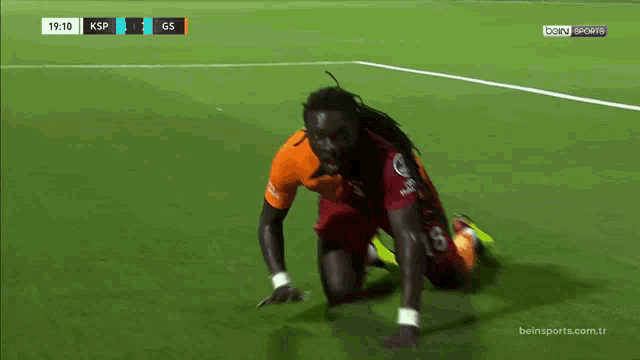 a soccer player is kneeling down on the field during a bein sports match