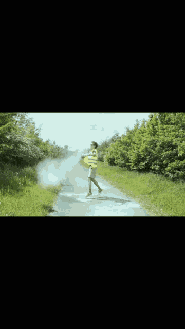 a person wearing a yellow vest with the number 10 on it walking down a road