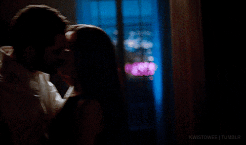 a man and a woman are kissing in a dark room with the words kwistowee tumblr below them