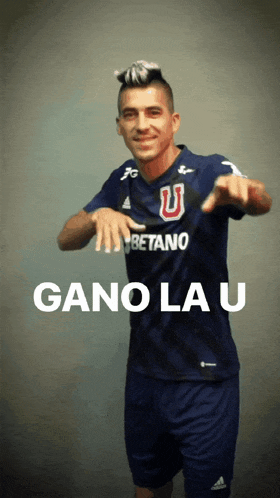 a man wearing a betano jersey is pointing at the camera