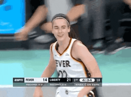 a female basketball player wearing a jersey that says fever