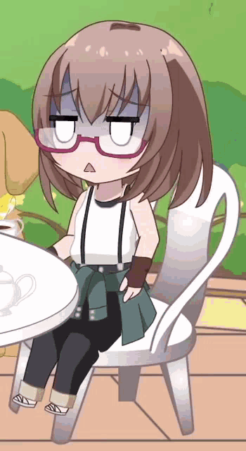 a girl with glasses is sitting at a table