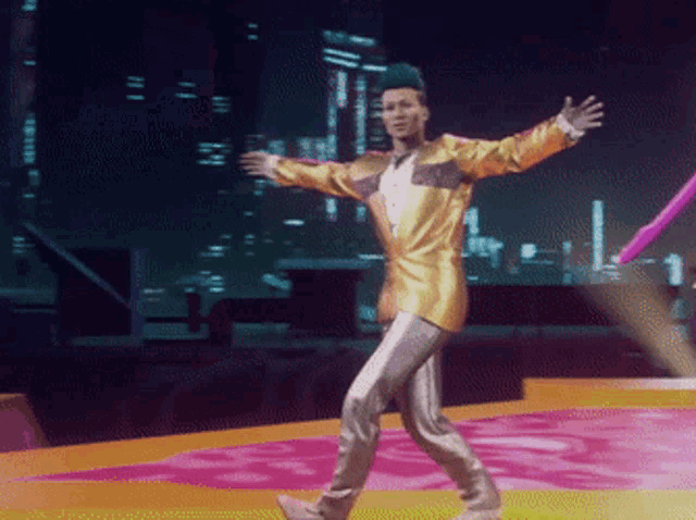 a man in a gold suit is walking on a stage