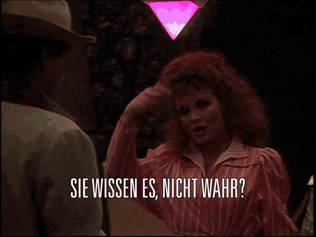a woman in a pink dress is talking to a man in a cowboy hat and the words sie wissen es nicht wahr