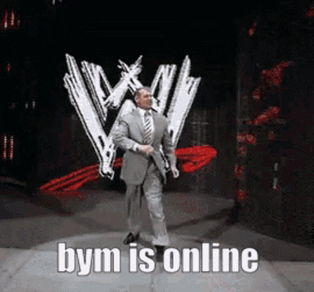 a man in a suit and tie is dancing in front of a w logo and the words bym is online below him