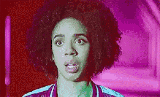a woman with an afro is making a surprised face in a pixelated image .