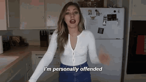 a woman stands in front of a refrigerator and says " i 'm personally offended "
