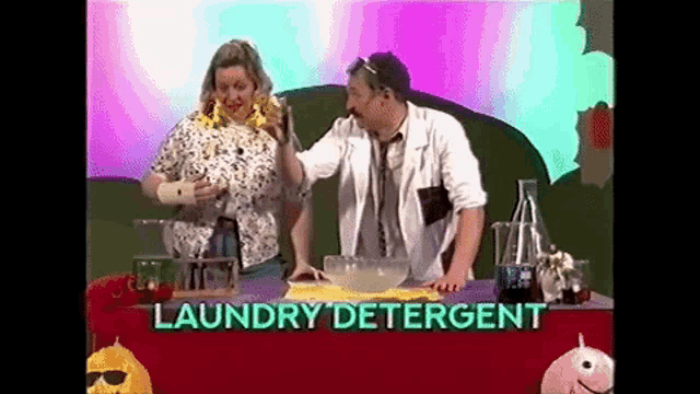 a man and a woman are sitting at a table with a bowl of laundry detergent in front of them .