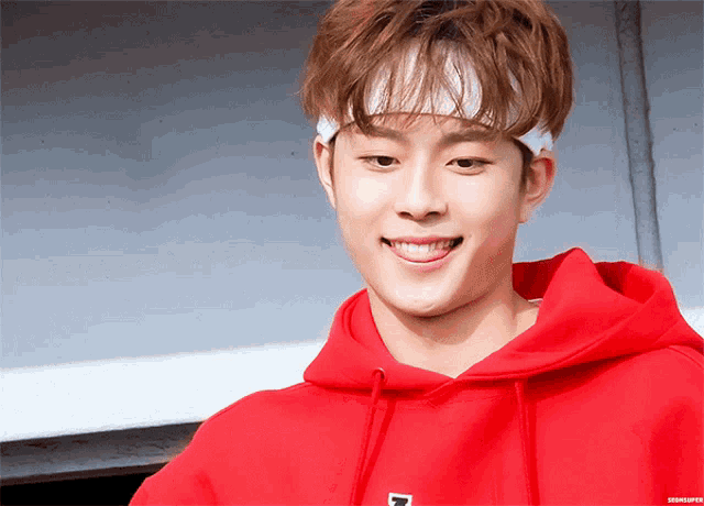 a young man wearing a red hoodie and a headband with the letter n on it