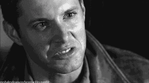 a close up of a man 's face with a serious look on his face in a black and white photo .