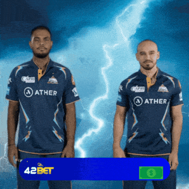 two men wearing blue shirts that say ather on them