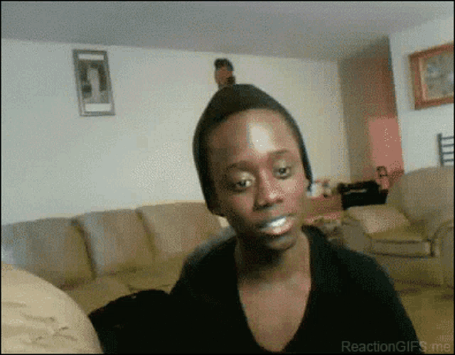 a man sitting on a couch with a toothbrush in his mouth