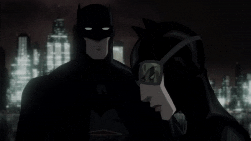 batman and catwoman are standing next to each other in front of a city skyline