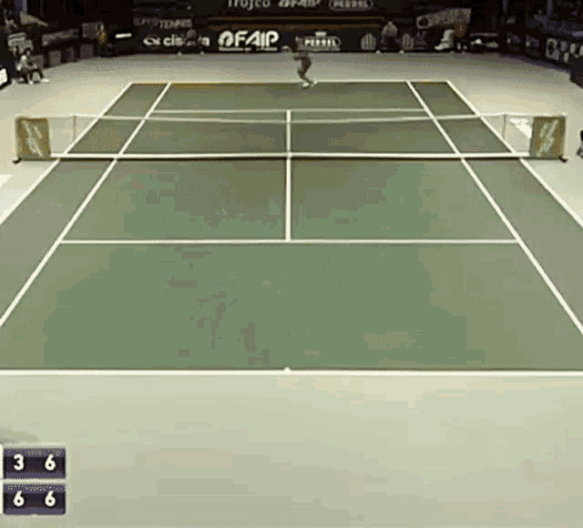 a tennis game is being played on a court with advertisements for fair on the sidelines
