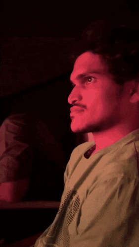 a man in a green shirt is looking to the left