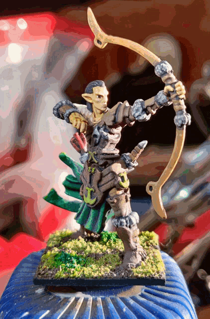 a small figurine of a man with a bow and arrow
