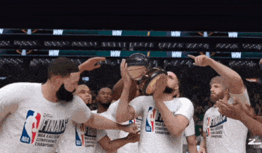 a group of basketball players wearing white shirts that say nba eastern conference champions