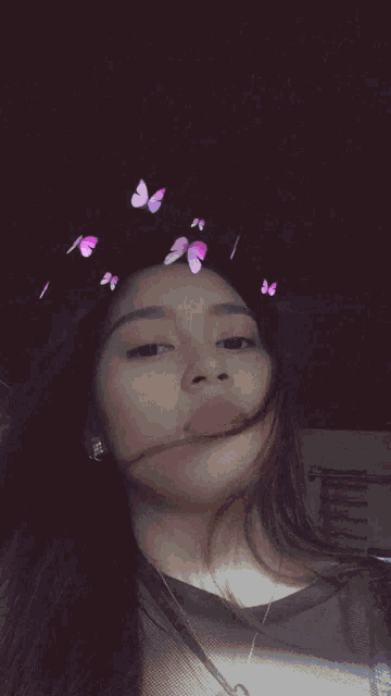 a girl with butterflies on her head takes a selfie