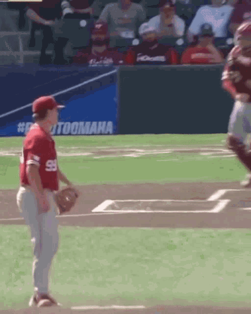 a baseball player in a red uniform with the number 59 on the back