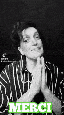 a black and white photo of a woman with her hands folded and the word merci in green