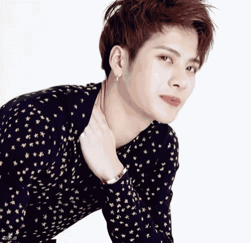 a young man wearing a black sweater with stars on it