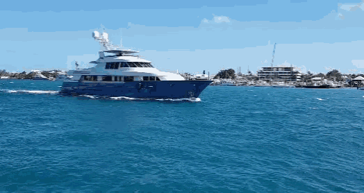 a large blue and white yacht is floating on the water