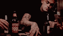 a man sitting at a table with a bottle of star beer in front of him
