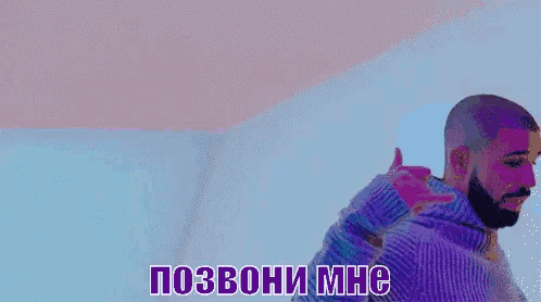 a man in a blue sweater is making a hand gesture in a foreign language .