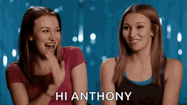 two girls are laughing and one of them is saying hi anthony