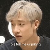 a young man with blonde hair is making a funny face and says `` pls tell me ur joking '' .