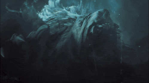 a person is swimming in the water with a monster in the background