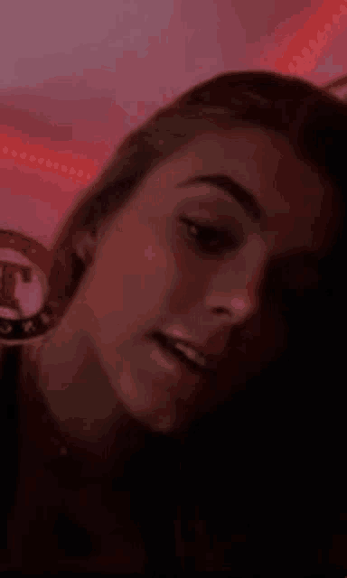 a close up of a woman 's face with a red background .