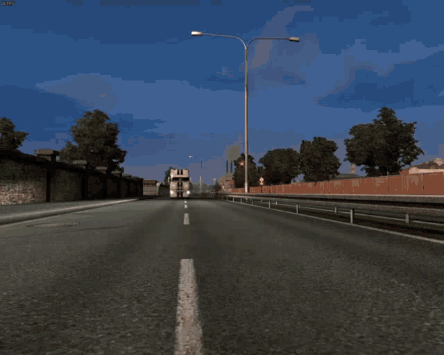 a daf truck is driving down a road with trees in the background