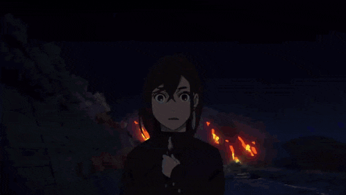a silhouette of a person standing in front of a large explosion