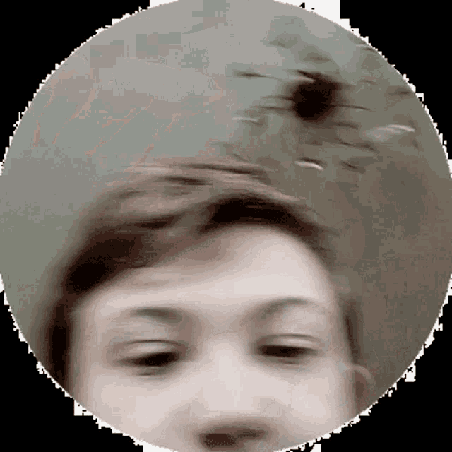 a blurry picture of a person 's face in a circle with a black background