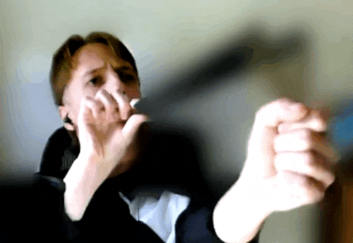 a man is holding something in his hands and making a funny face