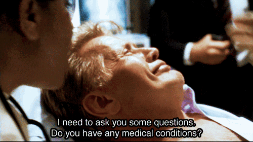 a man is laying in a hospital bed with the words " i need to ask you some questions do you have any medical conditions " above him