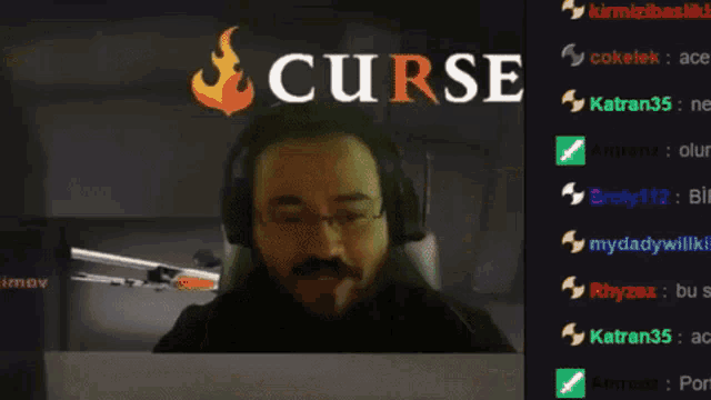 a man wearing headphones is playing a video game with the words curse on the screen