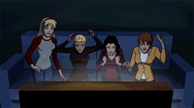 a group of women are sitting on a couch hugging