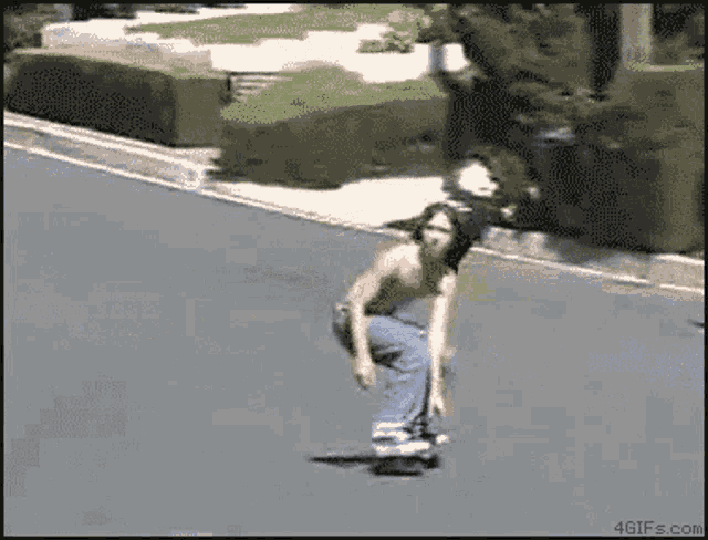 a shirtless man is riding a skateboard down a street ..