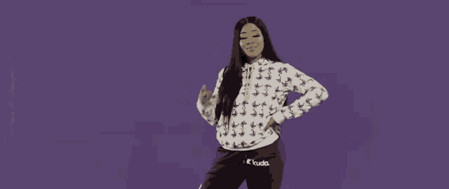 a woman wearing a white sweatshirt with dollar signs on it